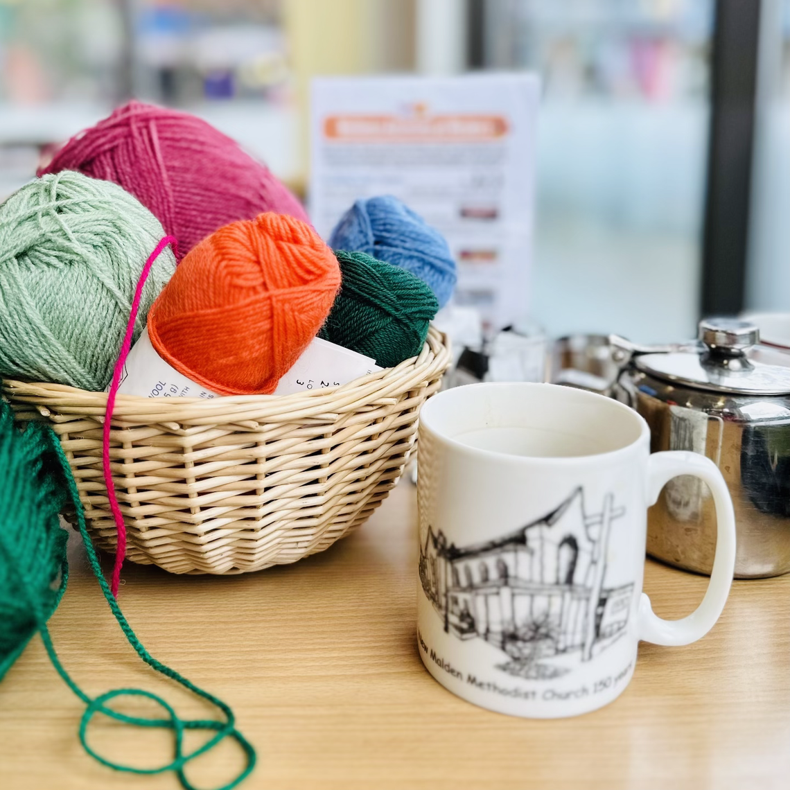 Coffee mug and yarns in basket